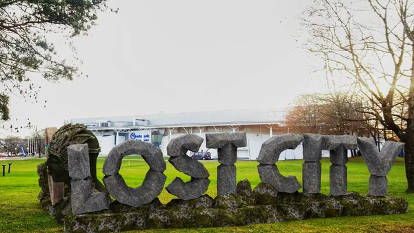 The sign seen from the lawn, readable from the road