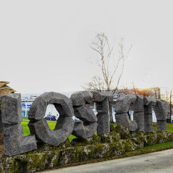 Stone letters LOST CITY on a mossy rock base