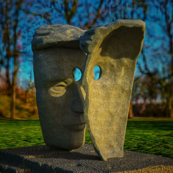 Stone-look version: the two faces seen from the side, the eye openings framing the sky