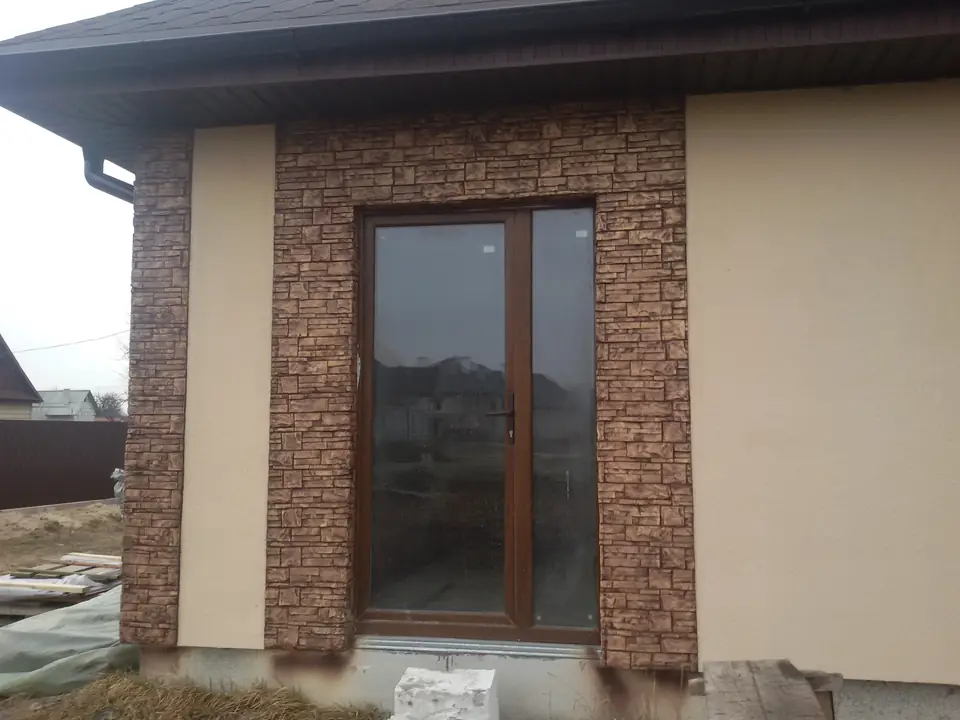 A French window framed by a stone-clad surround