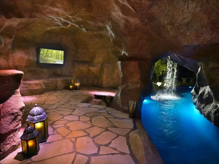 Cave-style room with a stone-textured floor and a lit pool