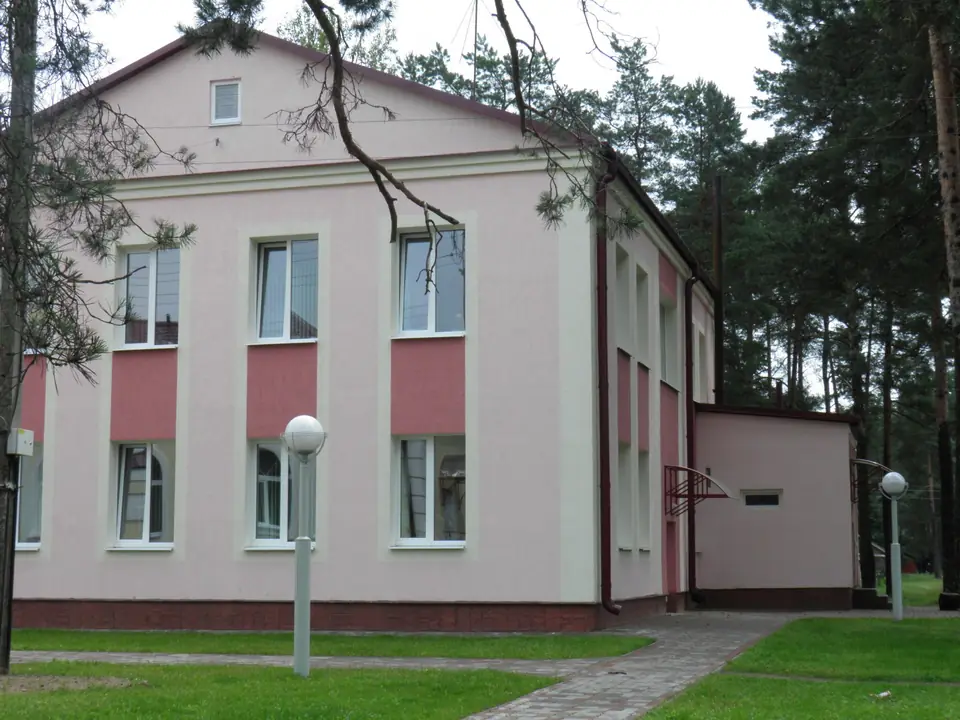 A pink and white building with a stone-effect plinth