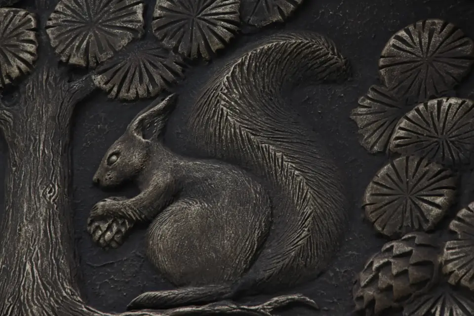 A squirrel in relief among pine branches