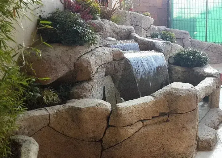 A garden waterfall tumbling over rock steps
