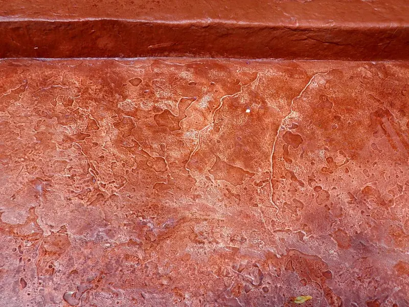 Close-up of the stamped red-brown surface