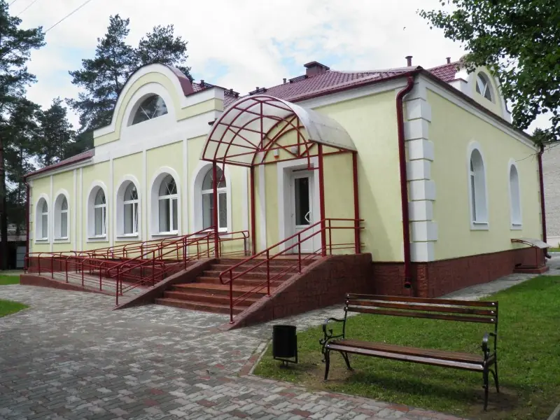 The building from the side with a canopy over the entrance and ramp