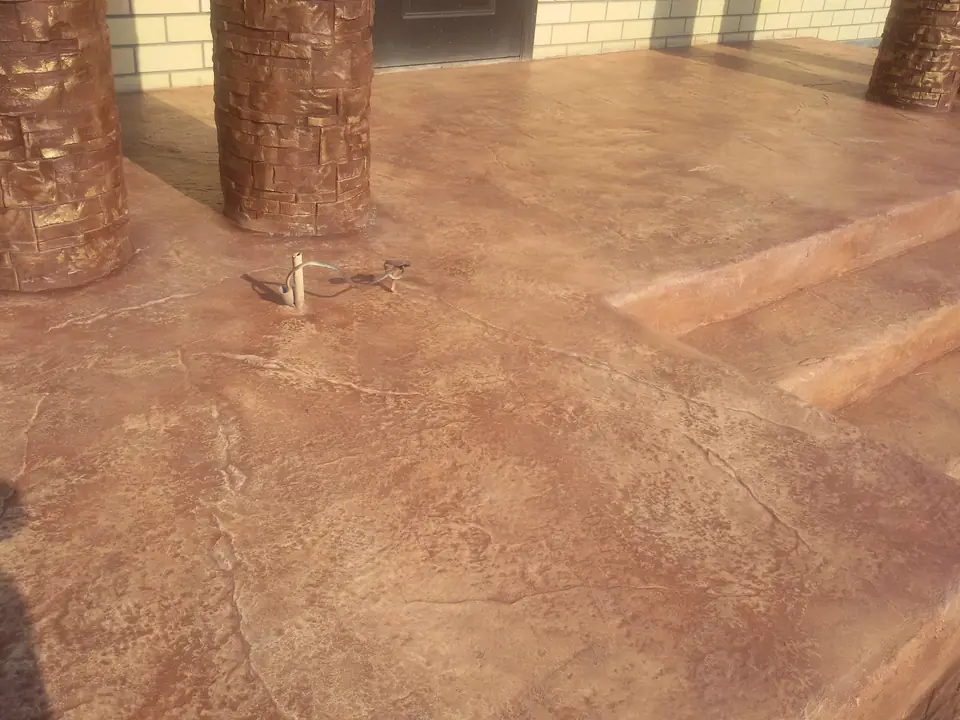 Red-brown stamped steps and tree-trunk columns in close view