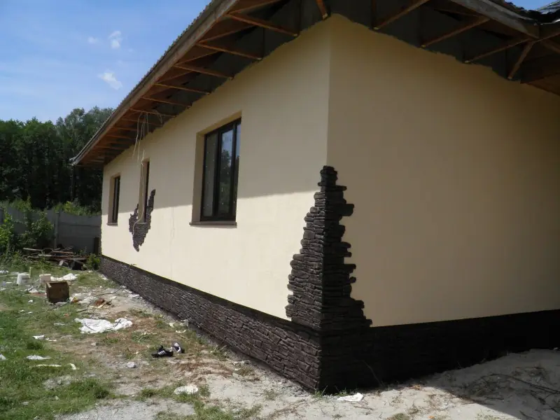 The same stone accent climbing the corner of a cream house
