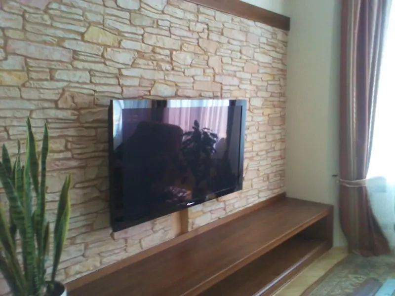 Living-room wall clad in layered stone around a wall-mounted television