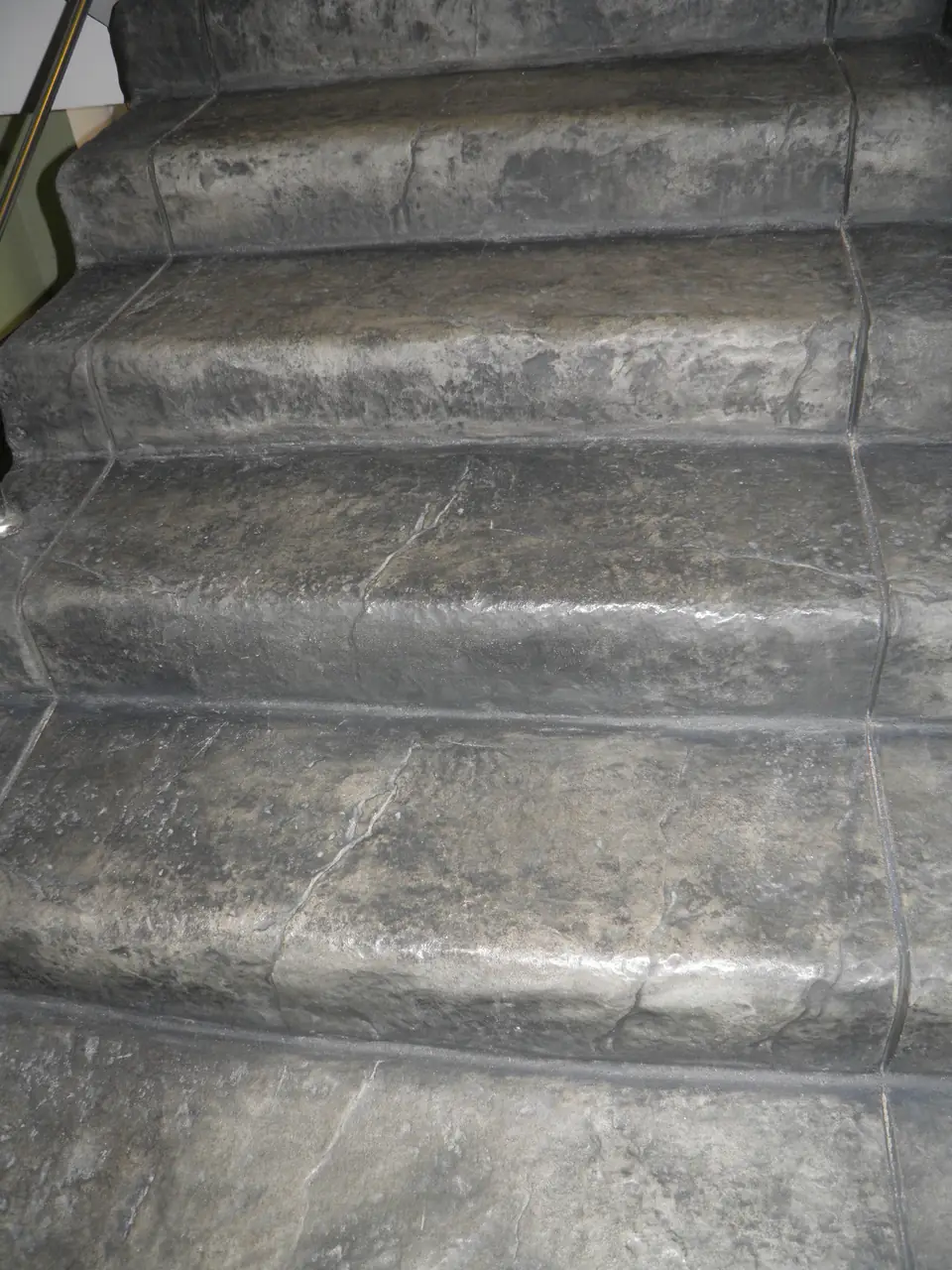 Close-up of stair treads with a stamped slate texture
