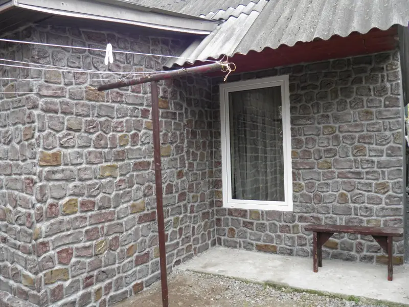 A window and a small canopy over a bench