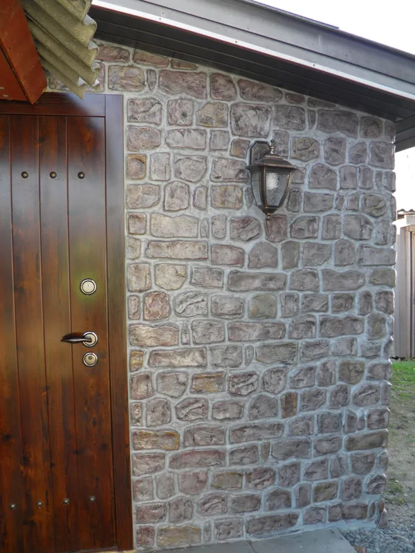 Plank door and lantern on the stone wall