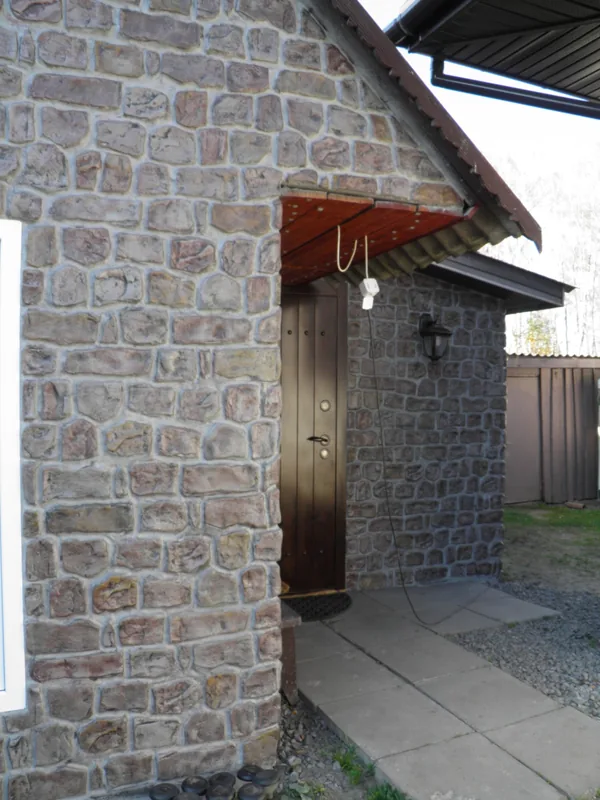 The entrance porch with a timber door and a lantern