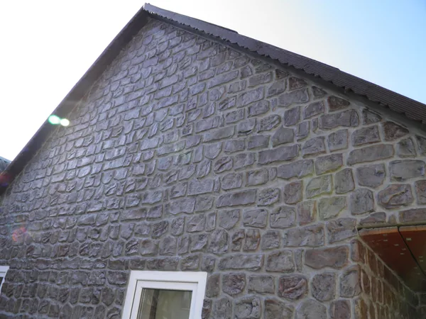 The gable from below against the sky