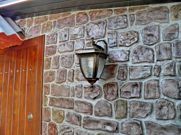 Lantern on the stone wall: every stone coloured in its own tone
