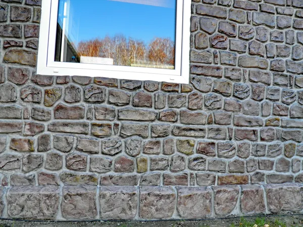 Large rounded stones of the plinth under the window