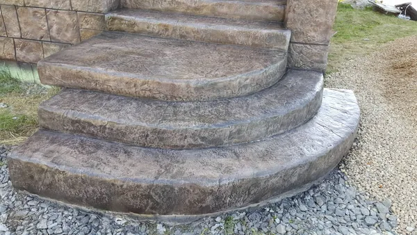 Curved bottom steps: textured treads and rough stone edges