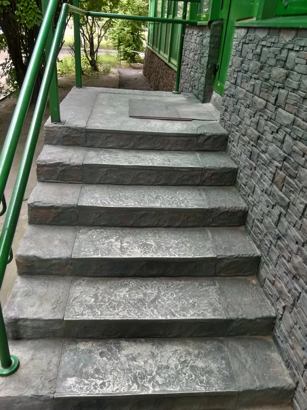 From above: textured treads and the stone wall beside them
