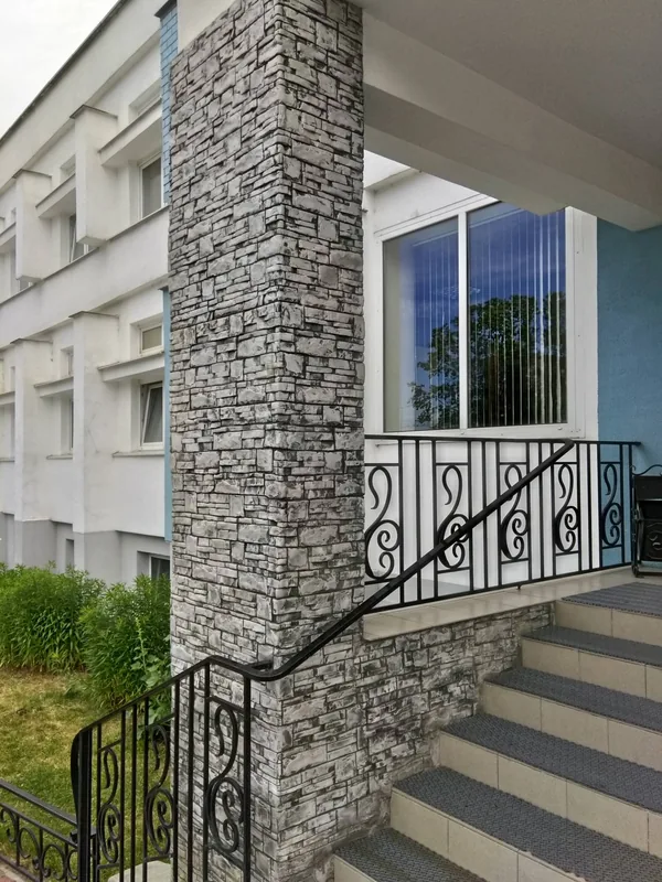 A pillar beside the entrance stairs