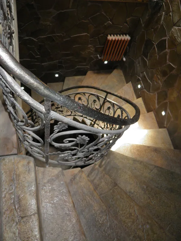 From above: treads winding around the forged railing