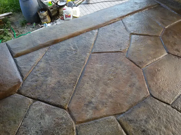 The edge of the terrace: a long kerb stone above the slabs