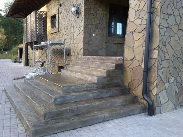 The two-flight entrance stair between flagstone walls