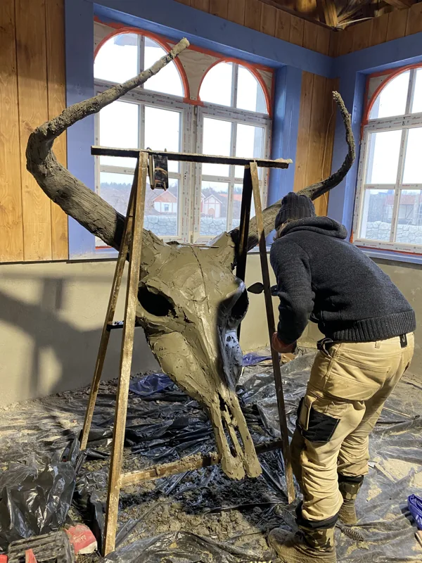 Sculpting a giant horned skull on its support frame